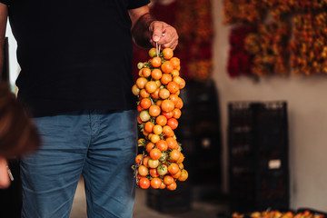 Sticker - PUGLIA / ITALY -  AUGUST 2019: The old tradition of hanging cherry tomatoes on the wall to preserve them for wintrr time in the south of Italy