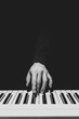 © princeoflove - BW male musician hand playing on piano keys. music background
