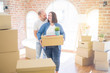 © Krakenimages.com - Young couple moving to a new home, smiling happy holding cardboard boxes