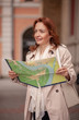 One mature woman, holding a city map.