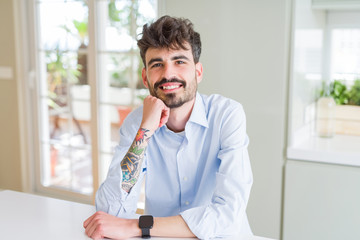 Wall Mural - Handsome young man smiling cheerful at the camera with a big smile on face showing teeth