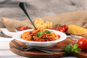 Plate of delicious spaghetti Bolognaise or Bolognese with savory minced beef and tomato sauce garnished with parmesan