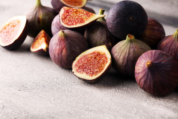 Wall Mural - Fresh figs. Food Photo. whole and sliced figs on beautiful rustic background.