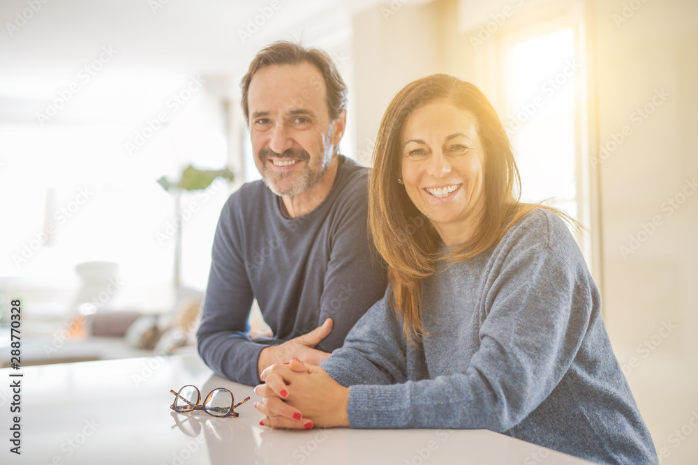 Romantic middle age couple sitting together at home - obrazy, fototapety, plakaty 