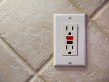 Ground Fault Interrupter Electricity Receptacle And Wall Plate. Residential Electric Socket Plug With GFI Reset Button.