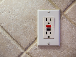 Ground fault interrupter electricity receptacle and wall plate. Residential electric socket plug with GFI reset button.