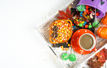 Halloween Concept Of Relaxing With Coffee And A Tray Of Candy And Treats, Flat Lay Overhead With Copy Space.