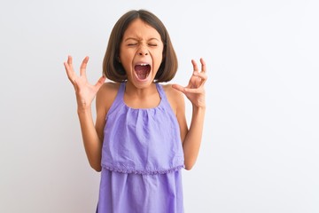 Sticker - Young beautiful child girl wearing purple casual dress standing over isolated white background celebrating mad and crazy for success with arms raised and closed eyes screaming excited. Winner concept