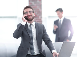 Sticker - Confident young man talking on phone in office