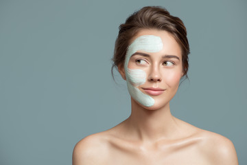 Wall Mural - Portrait of beautiful woman with bluel cream mask on her face.