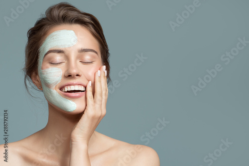 Fotomural Portrait of beautiful woman with bluel cream mask on her face.