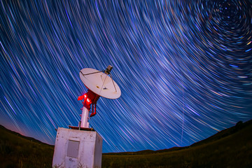 radio telescope on the background of stellar tracks