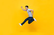 © Atstock Productions - Energetic excited young Asian man in casual clothes jumping in yellow background