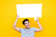 © Atstock Productions - Happy smiling young handsome Asian man holding speech bubble