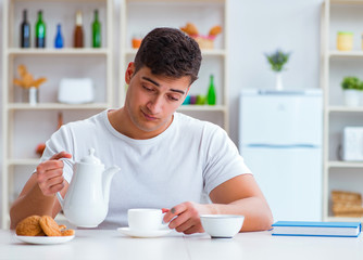 Wall Mural - Man falling asleep during his breakfast after overtime work