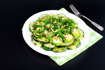 Wall Mural - Fried zucchini with green greens, garlic and walnuts.