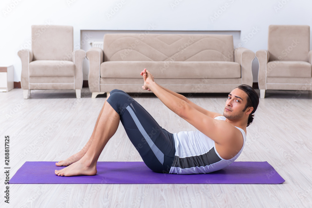 Young man training and exercising at home - obrazy, fototapety, plakaty 