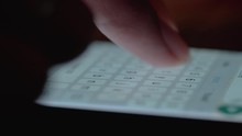 extreme close up of a finger typing on mobile phone screen texting and writing message