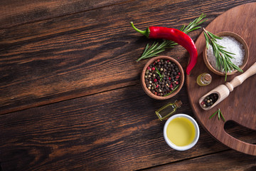 Wall Mural - Salt, black seed pepper, branch of rosemary, red hot chili