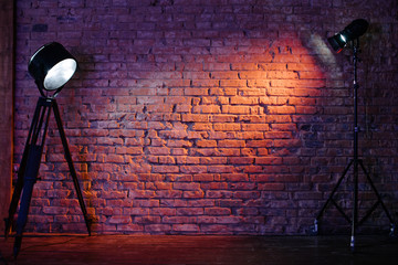 Old retro red brick wall being lit by a stage light bulb light. Constant light modifier projecting light on it