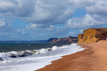 Wall Mural - Freshwater Bay beach and waves Dorset view towards sandstone cliffs, West Bay and Golden Cap