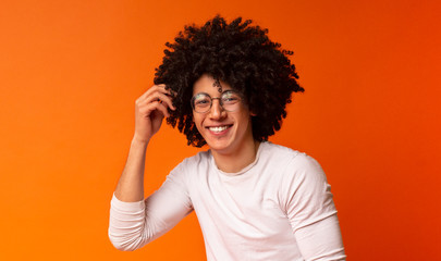 Wall Mural - Carefree black guy in glasses with bushy hairstyle laughing