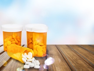 Canvas Print - Medication pills in pills bottles on background