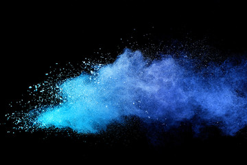 Blue sky color powder explosion on black background.