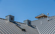 Ribbed Metal Roof and Cupolas Under Blue Skies