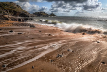 Outgoing Tide At Bracelet Bay On The Gower Peninsula In Swansea, South Wales, UK