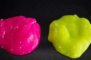 pink and yellow slime on a dark grainy background