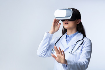 Wall Mural - Lady Doctor Wearing Virtual Reality Headset, White Background