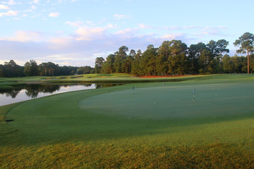 Beautiful summer morning landscape with southern golf course.  Scenic view with green grass lawn covered by morning dew during sunrise. True Blue, Pawleys Island, South Carolina, USA.