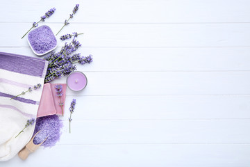 Wall Mural - Lavender flowers with spa salt, soap and candle on white wooden table