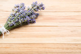 Fototapeta Lawenda - Lavender flowers on brown wooden table