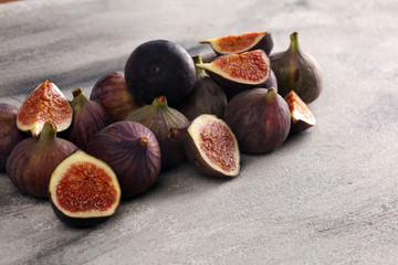 Wall Mural - Fresh figs. Food Photo. whole and sliced figs on beautiful rustic background.