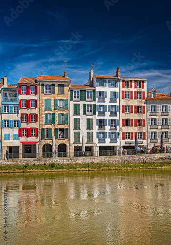 Colorful houses at the Nive river embankment in Bayonne, France