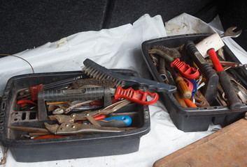 Plastic toolboxes with pliers, screwdriver, brush, hammer, drills and wrench