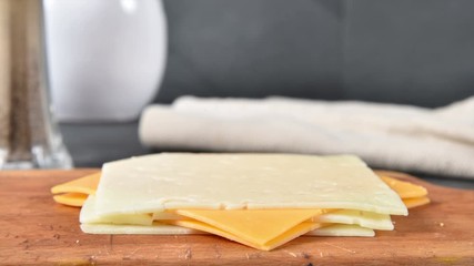 Poster - Slices of swiss and cheddar cheese vanishing from a stack, stop motion animation