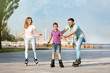 © New Africa - Happy family roller skating on city street