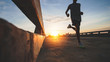 © sutadimages - Athlete runner feet running on road, Jogging concept at outdoors. Man running for exercise.