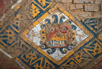 A painted mural bas relief depicting the creator God Ai Apaec in the Moon Pyramid or Huaca de la Luna built of the Moche civilization built in adobe bricks in the desert around Trujillo, Peru.