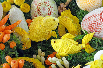 Sticker - Beautiful Thai style carving fruits and vegetables in fish among sea anemones shaped. Royal Thai cuisine decorative style. Selective focus