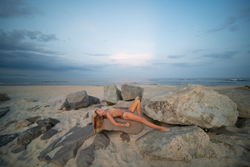 Beautiful young woman in bikini on the beach