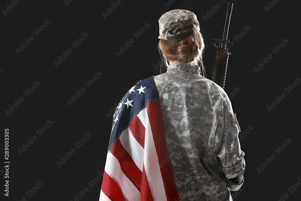 Young female soldier with USA flag on dark background, back view Stock ...