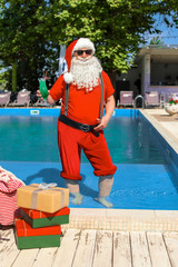 Wall Mural - Santa Claus with cocktail resting at resort