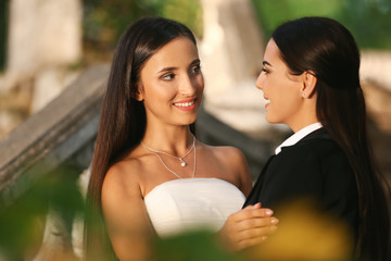 Wall Mural - Beautiful lesbian couple on their wedding day outdoors