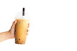 Close up young asian woman hand holding takeaway plastic cup of delicious iced bubble milk tea and black pearls isolated on white background with clipping path.Healthy refreshing summer drink concept.