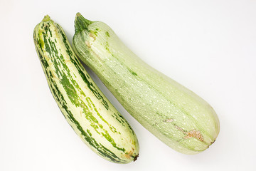 Wall Mural - Summer harvest of vegetables concept. Zucchini on a light white background.