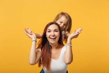 Wall Mural - Woman in light clothes have fun with cute child baby girl 4-5 years old. Mommy little kid daughter isolated on yellow background studio portrait. Mother's Day love family parenthood childhood concept.